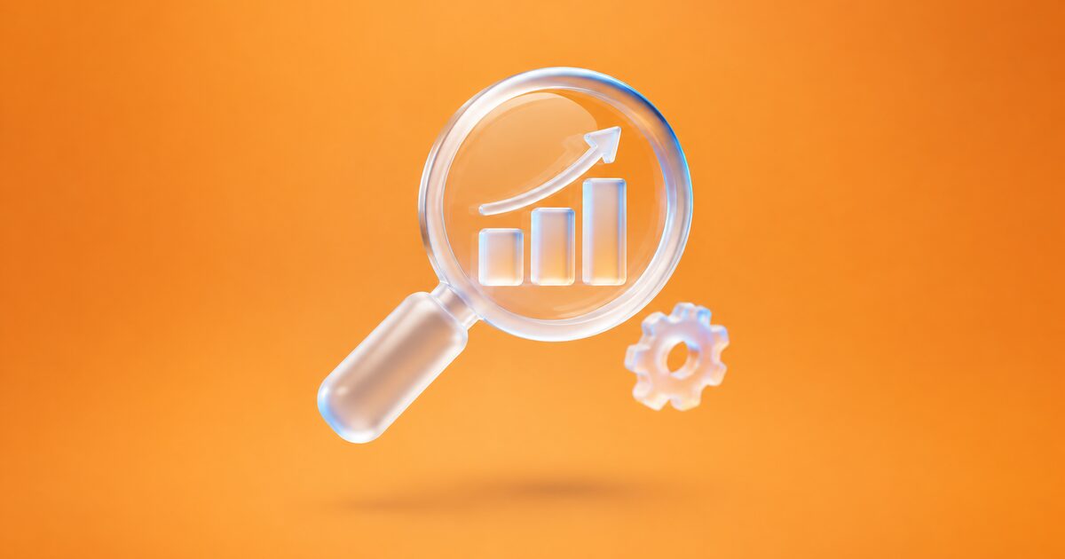 Glass magnifying glass over a rising bar chart, with a small gear, on an orange gradient